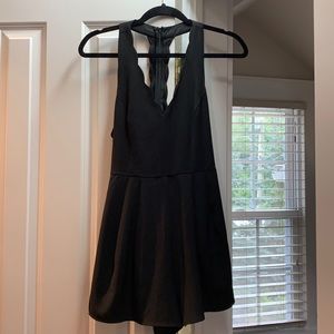 Lush black romper with adorable scalloped detail